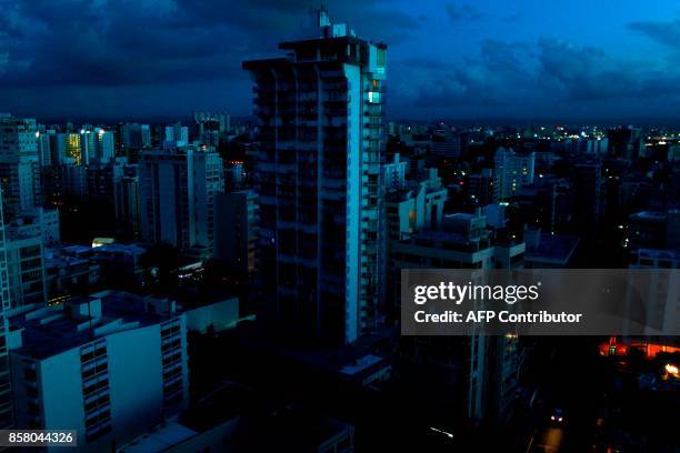 Blacked out buildings are seen in a tourist zone with lights only showing in buildings that have generators in San Juan, Puerto Rico on October 4,...