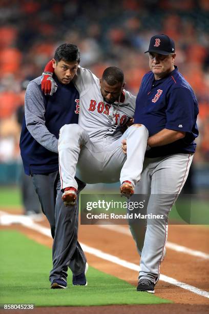 Eduardo Nunez of the Boston Red Sox is carried off the field by Red Sox trainer Masai Takahashi and manager John Farrell after suffering an injury in...