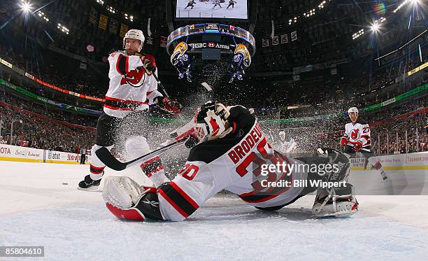 Martin Brodeur of the New Jersey Devils makes a sliding second period save against the Buffalo Sabres on April 4, 2009 at HSBC Arena in Buffalo, New...