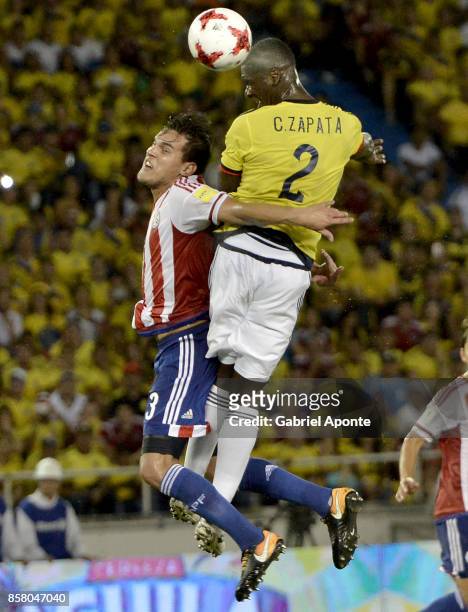 Cristian Zapata of Colombia jumps for a header with Gustavo Gomez of Paraguay during a match between Colombia and Paraguay as part of FIFA 2018 World...