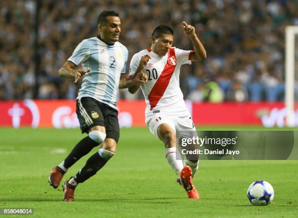 Gabriel Mercado of Argentina fights for the ball with Edison Flores of Peru during a match between Argentina and Peru as part of FIFA 2018 World Cup...