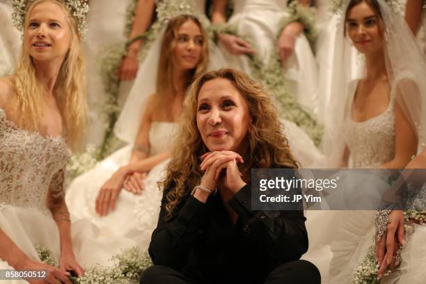 Designer Reem Acra poses with models at the conclusion of her Reem Acra FW 2018 Bridal Show at the New York Public Library on October 5, 2017 in New...