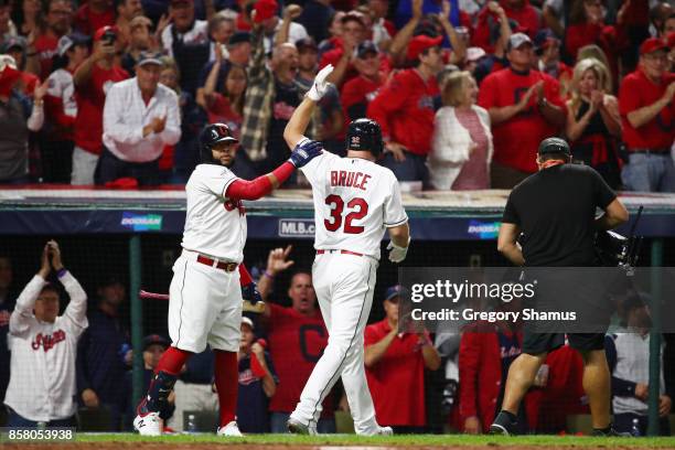 Jay Bruce is congratulated by his teammate Carlos Santana of the Cleveland Indians after hitting a two-run home run during the fourth inning against...