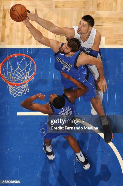 Jeff Withey of the Dallas Mavericks grabs the rebound against the Orlando Magic during a preseason game on October 5, 2017 at Amway Center in...