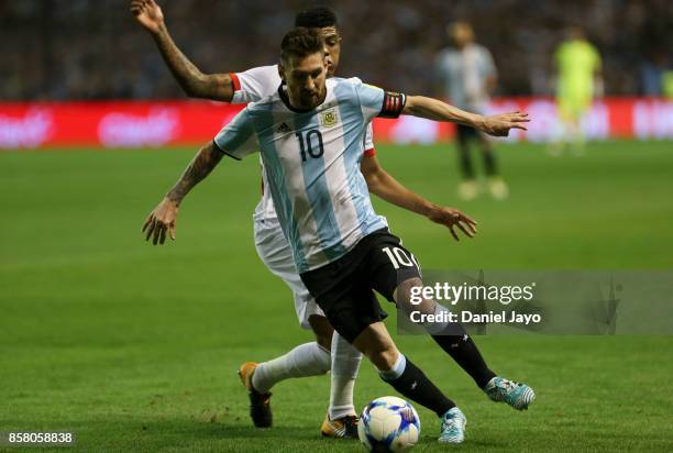 Lionel Messi of Argentina fights for the ball with Wilder Cartagena of Peru during a match between Argentina and Peru as part of FIFA 2018 World Cup...