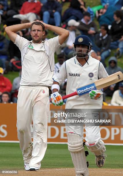 New Zealand cricketer Daniel Vettori reacts as Indian batsman Gautam Gambhir completes a run during the third day of the final Test match between New...