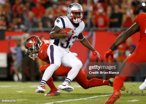 Running back Dion Lewis of the New England Patriots evades linebacker Cameron Lynch of the Tampa Bay Buccaneers during a carry in the first quarter...