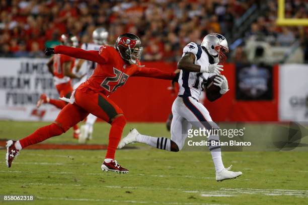 Wide receiver Brandin Cooks of the New England Patriots evades cornerback Vernon Hargreaves of the Tampa Bay Buccaneers during a carry in the first...