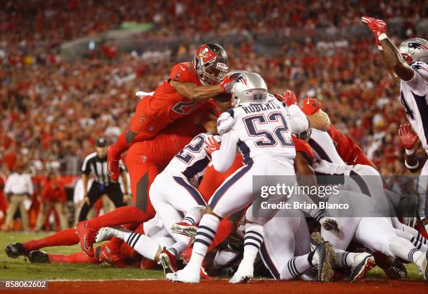 Running back Doug Martin of the Tampa Bay Buccaneers goes over the top on a one-yard rush for a touchdown during the second quarter of an NFL...