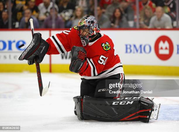 Corey Crawford of the Chicago Blackhawks makes a save against the Pittsburgh Penguins during the season opening game at the United Center on October...