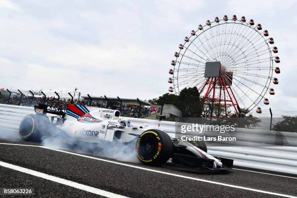 Felipe Massa of Brazil driving the Williams Martini Racing Williams FW40 Mercedes locks a wheel on track during practice for the Formula One Grand...