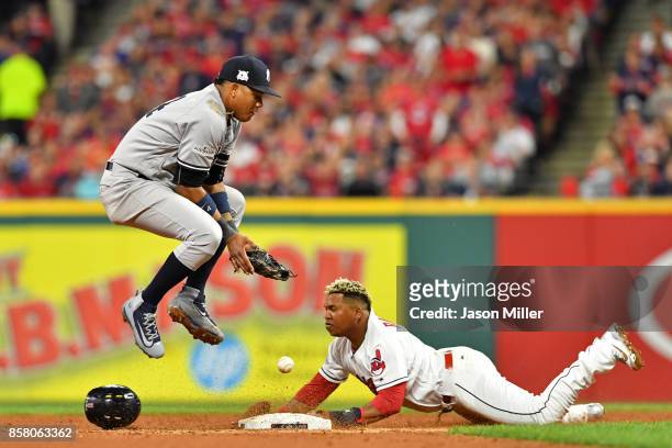 Jose Ramirez of the Cleveland Indians slides in safely against Starlin Castro of the New York Yankees on a wild pitch in the fifth inning during game...