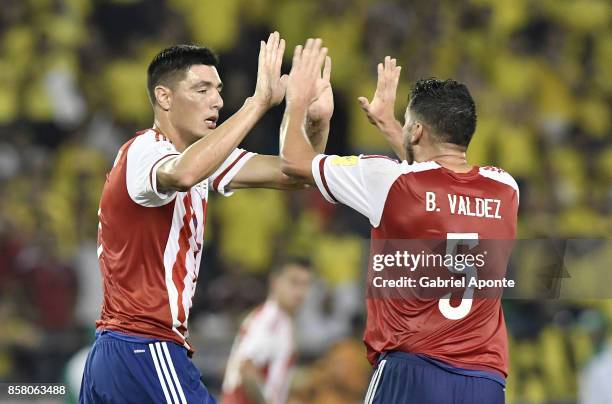 Oscar Cardozo of Paraguay celebrates with teammate Bruno Valdez after scoring the first goal of his team during a match between Colombia and Paraguay...