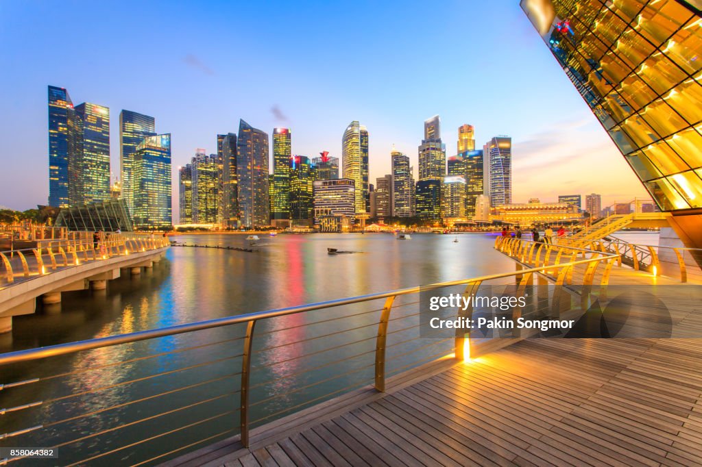 Colorful lights architecture business building and financial district in sunset time at Singapore City.