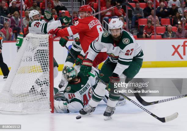 Kyle Quincey of the Minnesota Wild diverts a shot on goal after goalie Devan Dubnyk of the Minnesota Wild was knocked down by Justin Abdelkader of...