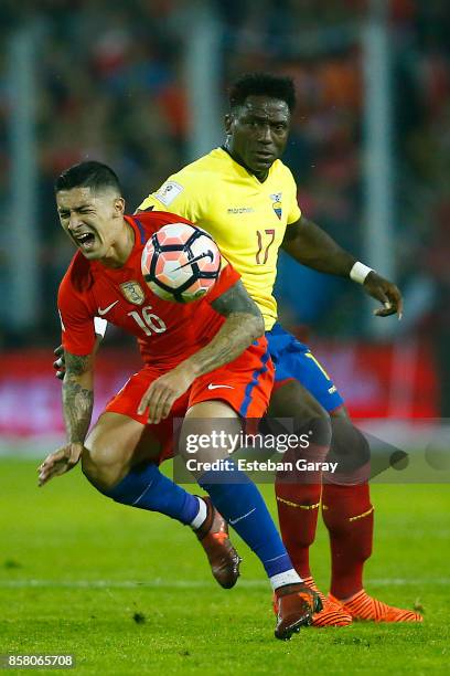 Pedro Pablo Hernandez of Chile fights for the ball with Roberto Ordonez of Ecuador during a match between Chile and Ecuador as part of FIFA 2018...