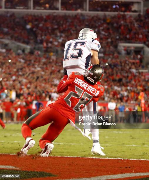 Wide receiver Chris Hogan of the New England Patriots hauls in a five-yard touchdown pass in the end zone from quarterback Tom Brady while getting...