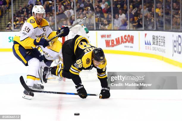 Roman Josi of the Nashville Predators checks David Pastrnak of the Boston Bruins during the third period at TD Garden on October 5, 2017 in Boston,...