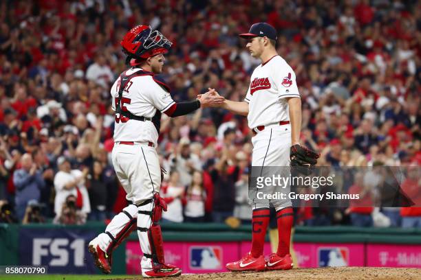 Roberto Perez congratulates Trevor Bauer of the Cleveland Indians as he is taken out of the game during the seventh inning against the New York...