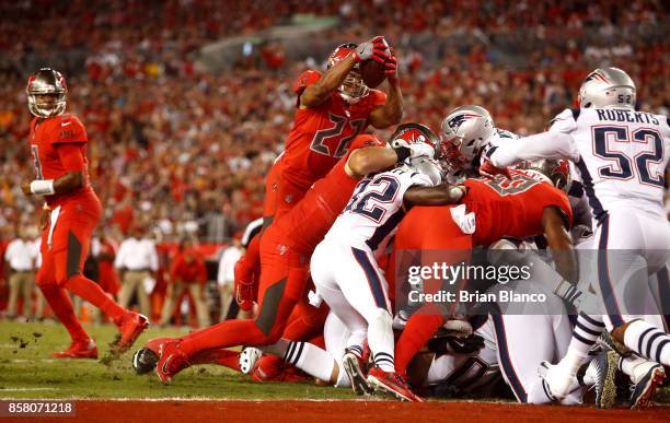 Running back Doug Martin of the Tampa Bay Buccaneers goes over the top on a one-yard rush for a touchdown during the second quarter of an NFL...