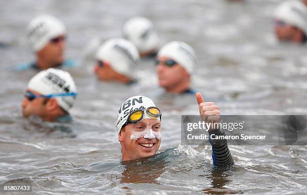 Competitior signals to friends prior to the start of the swim leg of the 2009 Ironman Australia on April 5, 2009 in Port Macquarie, Australia.