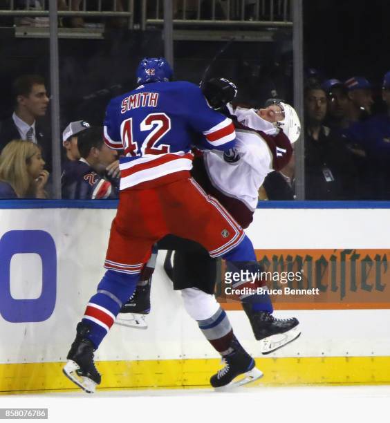 Brendan Smith of the New York Rangers checks Tyson Barrie of the Colorado Avalanche at Madison Square Garden on October 5, 2017 in New York City. The...