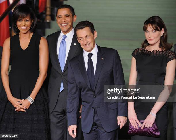 First Lady Michelle Obama, U.S. President Barack Obama, French President Nicolas Sarkozy and French First Lady Carla Bruni-Sarkozy pose as they...