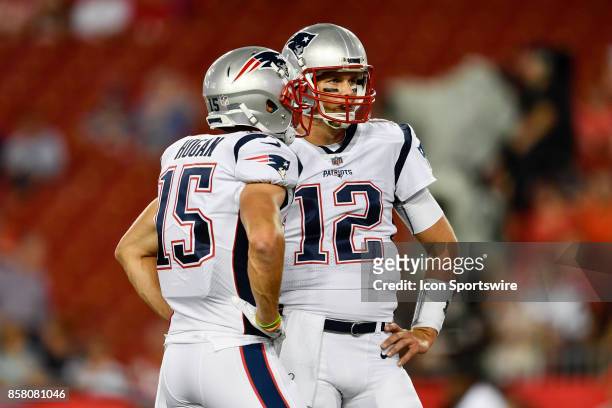 New England Patriots quarterback Tom Brady talks with New England Patriots wide receiver Chris Hogan prior to an NFL football game between the New...