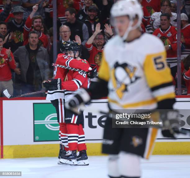 The Chicago Blackhawks' Patrick Kane and Ryan Hartman celebrate after Hartman scores against the Pittsburgh Penguins in the first period at the...