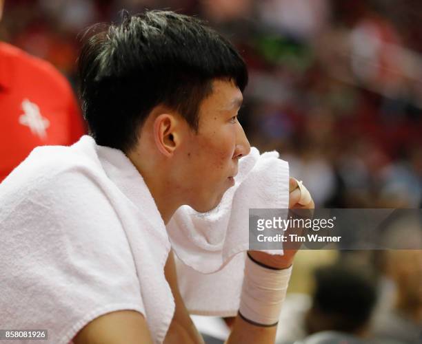 Zhou Qi of Houston Rockets rests on the bench in the fourth quarter against the Shanghai Sharks at Toyota Center on October 5, 2017 in Houston,...