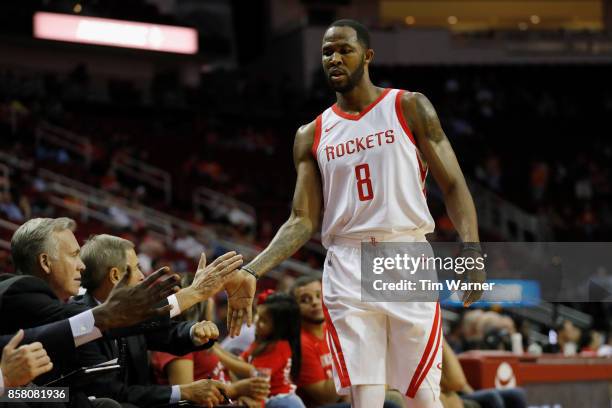 Chris Johnson of Houston Rockets is greeted by head coach Mike D'Antoni in the second half against the Shanghai Sharks at Toyota Center on October 5,...