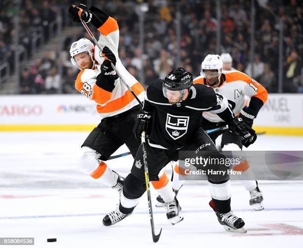 Claude Giroux of the Philadelphia Flyers and Derek Forbort of the Los Angeles Kings collide as they go after the puck during the first period during...