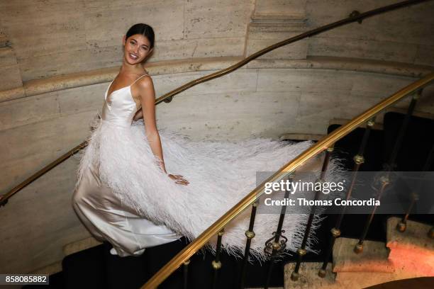 Model walks down a stairway before the Monique Lhuillier Spring 2018 Bridal Presentation at the Academy Mansion on October 5, 2017 in New York City.