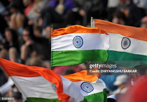 Indian cricket fans wave the Indian national flag to support the team, during the second day of the final Test match between New Zealand and India,...