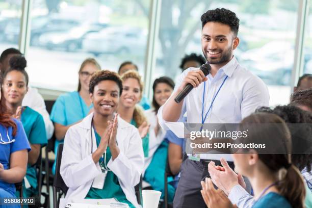 confident healthcare professionals attend continuing education class - healthcare seminar stock pictures, royalty-free photos & images