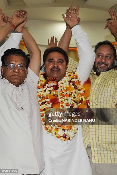 Indian Congress party election candidate and sitting Member of Legislative Assembly O.P Soni gestures with former Congress MLA Jasbir Singh Dimpa and...