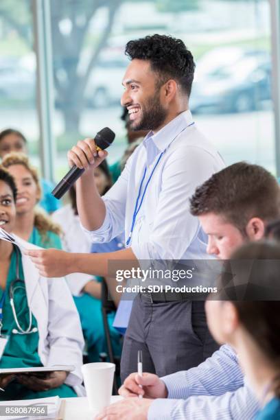 cheerful medical professional participates in panel discussion - male medical student stock pictures, royalty-free photos & images