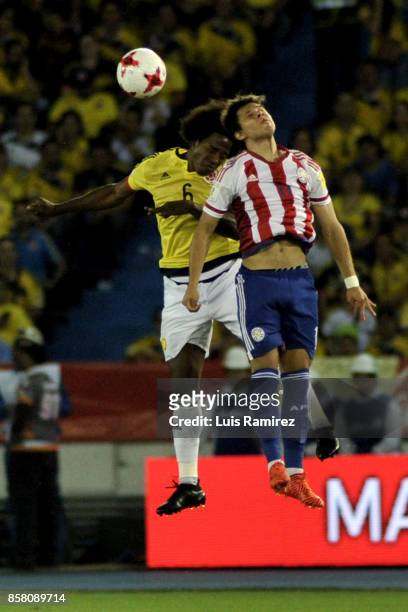 Carlos Sanchez of Colombia goes for a header with Angel Romero of Paraguay during a match between Colombia and Paraguay as part of FIFA 2018 World...