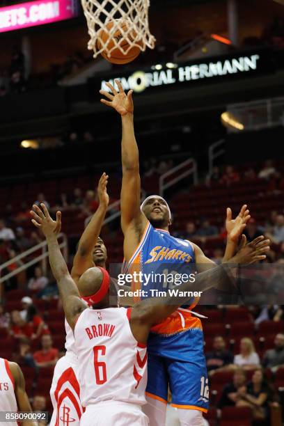 Josh Akognon of Shanghai Sharks shoots the ball defended by Bobby Brown of Houston Rockets in the second half at Toyota Center on October 5, 2017 in...