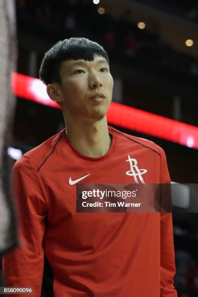 Zhou Qi of Houston Rockets watches from the bench in the fourth quarter against the Shanghai Sharks at Toyota Center on October 5, 2017 in Houston,...