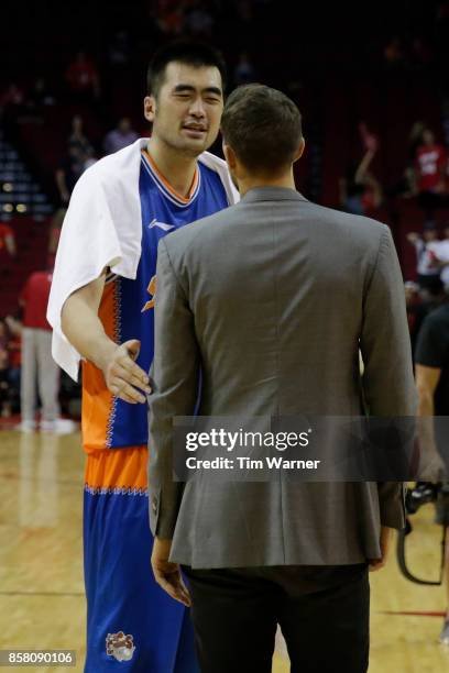 Zhang Zhaoxu of Shanghai Sharks talks with Ryan Anderson of Houston Rockets after an exhibition game at Toyota Center on October 5, 2017 in Houston,...