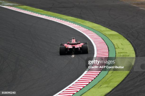 Ferrari's German driver Sebastian Vettel drives during the first practice round of the Formula One Japanese Grand Prix at Suzuka on October 6, 2017....