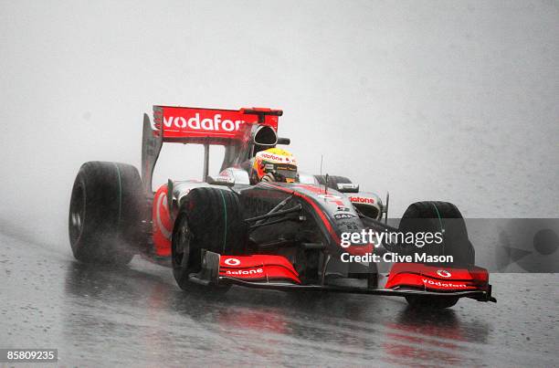 Lewis Hamilton of Great Britain and McLaren Mercedes drives during the rain curtailed Malaysian Formula One Grand Prix at the Sepang Circuit on April...