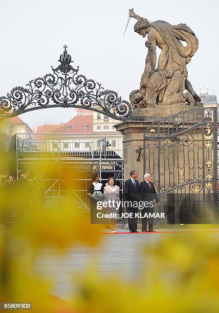 President Barack Obama , his wife Michelle , his Czech counterpart Vaclav Klaus and his wife Livia listen to national anthems at Prague's castle on...