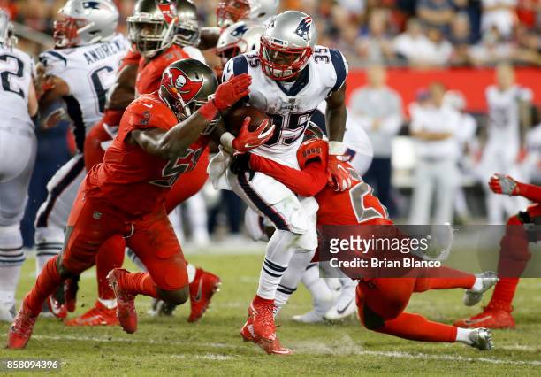 Running back Mike Gillislee of the New England Patriots runs for a gain of six yards against middle linebacker Kendell Beckwith of the Tampa Bay...