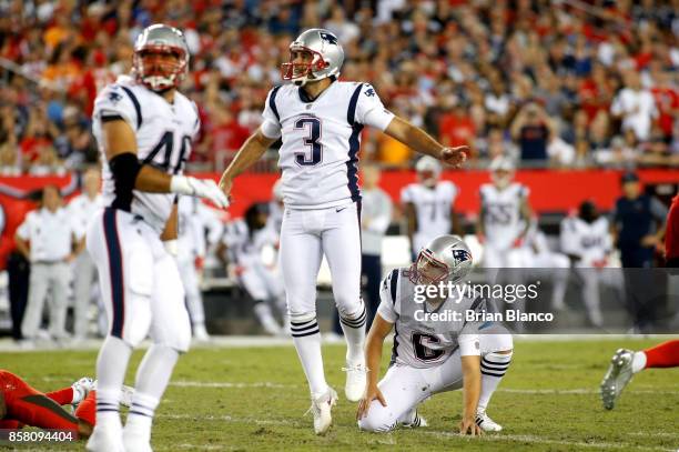 Kicker Stephen Gostkowski of the New England Patriots and punter Ryan Allen watch Gostkowski's 45-yard field goal during the third quarter of an NFL...