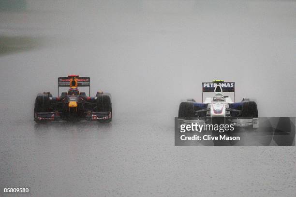 Mark Webber of Australia and Red Bull Racing and Nick Heidfeld of Germany and BMW Sauber drive during the Malaysian Formula One Grand Prix at the...