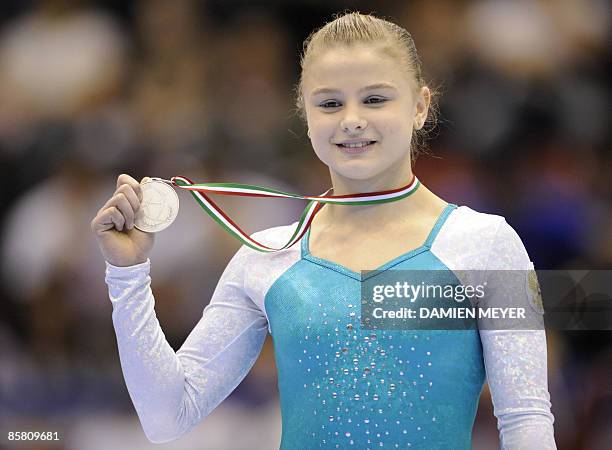 Silver medalist Russia's Yulia Berger poses on the podium of the vault competition of the Third European Women's Artistic Championships on April 5,...