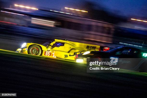 The ORECA LMP2 of Chris Miller, Stephen Simpson, of South Africa, and Misha Goikhberg, of Russia, races on the track during night practice at Road...