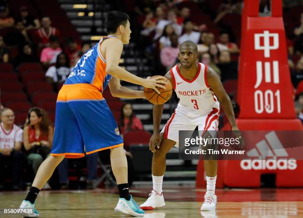 Chris Paul of Houston Rockets defends Shi Yuchen of Shanghai Sharks in the first half at Toyota Center on October 5, 2017 in Houston, Texas. NOTE TO...